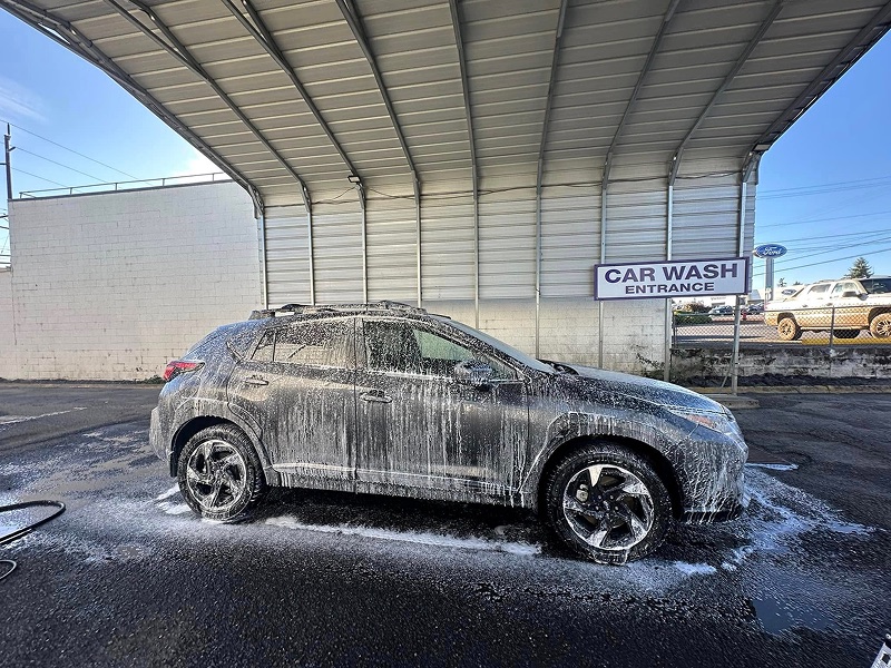 SUV covered in foam during a hand wash