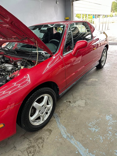 Polished red coupe inside the detailing shop