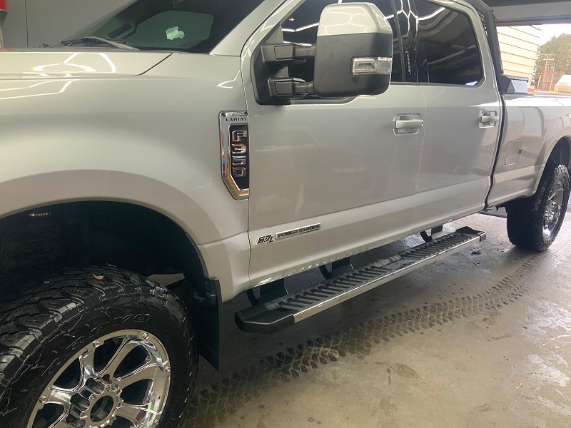 Clean white Ford pickup after detailing