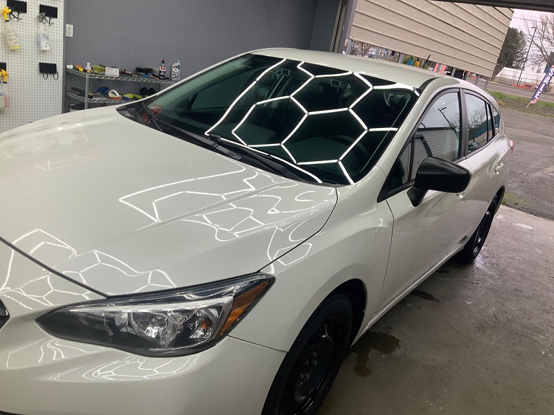 White sedan with a reflective polished finish